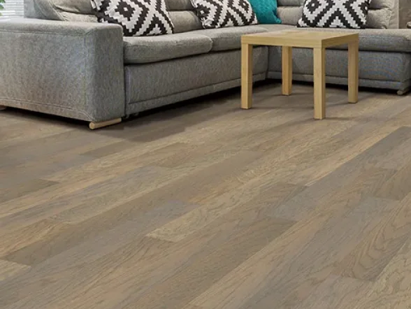 hardwood floors in room in grey sofa and decorative pillows
