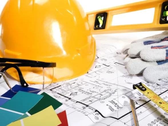 Yellow construction hat, measuring tape, paint swatches