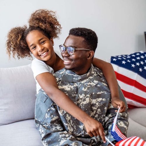 happy father and daughter sitting on the sofa